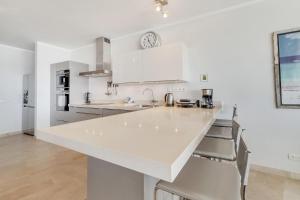 a white kitchen with a large white counter top at Seaside Governor Suite in Kralendijk