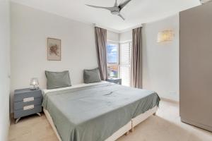 a bedroom with a large bed and a window at Seaside Governor Suite in Kralendijk