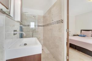 a bathroom with a sink and a shower at Seaside Governor Suite in Kralendijk