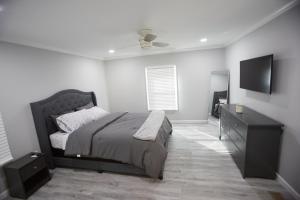 a bedroom with a bed and a flat screen tv at Decatur 2 BR Bliss Modern Comfort in Decatur