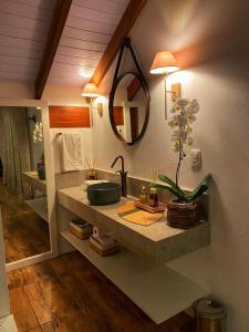 a bathroom with a sink and a mirror at Pousada La Lavande in Gramado
