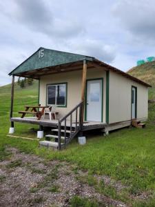 una casita con una mesa de picnic en un campo en Eagles Landing Campground, en Sturgis