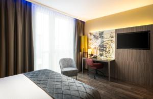 Ein Bett oder Betten in einem Zimmer der Unterkunft Leonardo Hotel Eschborn Frankfurt