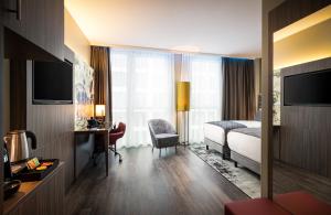 Ein Bett oder Betten in einem Zimmer der Unterkunft Leonardo Hotel Eschborn Frankfurt