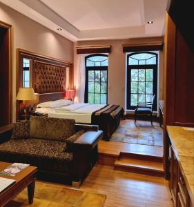 a hotel room with a bed and a couch at Sultan Inn Boutique Hotel in Baku