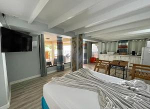 a bedroom with a bed with a tv on the wall at Castara Inn in Castara