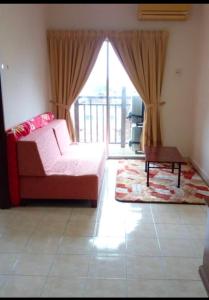 a living room with a couch and a table at Bukit Merah 99 Motel(Suria Apartment) in Kampong Selemat