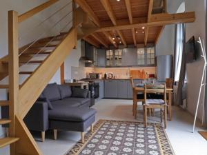 a living room with a couch and a table and a kitchen at Appartement L'Aigle, 2 pièces, 6 personnes - FR-1-497-140 in LʼAigle