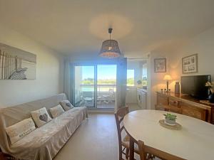 a living room with a couch and a table at Ploemeur Lomener T2 Balcon Vue Mer - FR-1-349-65 in Ploemeur +26 photos
