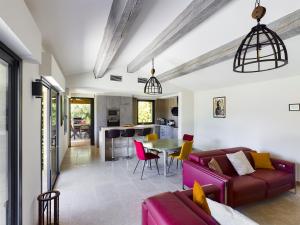 a living room with a couch and a table at Charmante villa au cœur d'Eygalières avec piscine chauffée - FR-1-599-19 in Eygalières