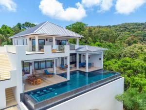 an aerial view of a house with a swimming pool at Ocean Pearl home in Roatan