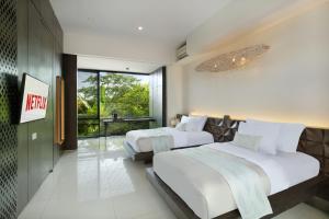 Postel nebo postele na pokoji v ubytování Monolocale Luxury Resort & Spa Seminyak by Ini Vie Hospitality