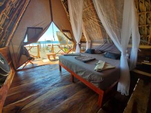 a bedroom with a bed in a tent at Entremares in Tonalá