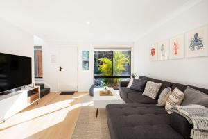 カルバーラ・ビーチにあるGumnut Pet Friendly 5 Mins Walk to Beachのソファとテレビのあるリビングルーム
