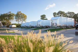 a row of mobile homes in a parking lot at Mycow Accommodation Mackay in Mackay