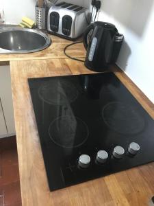 a black stove top on a counter in a kitchen at Highfield Road Apartment. in Rowley Regis