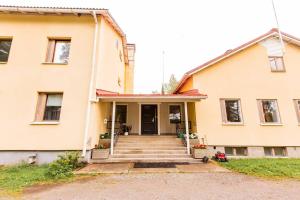 an old house with the front door open at Koivikko Lifestyle Center in Mikkeli