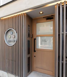 a door with a speaker on the side of a building at vacation rental SARAKU 茶楽来 in Osaka