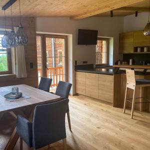 a kitchen and dining room with a table and chairs at Chalet Tuxer in Achenkirch