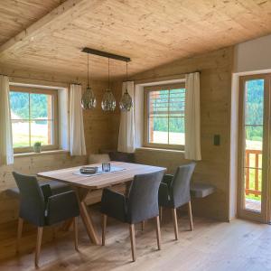a dining room with a table and chairs at Chalet Tuxer in Achenkirch