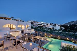 a view of a hotel patio with tables and a swimming pool at Alleys All-Suite Hotel & Spa in Pirgos