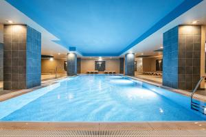 a large swimming pool with a blue ceiling at 3HB Guarana - All Inclusive in Albufeira
