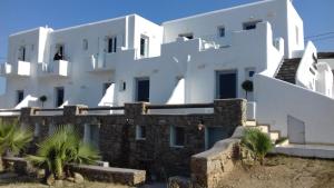 a large white building with palm trees in front of it at Paraga View in Paraga