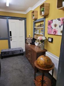 a room with a door and a table with flowers at The Residence - NO 8 in Edinburgh