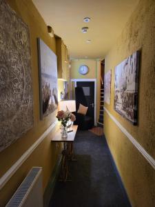 a hallway with a couch and a table with flowers on it at The Residence - NO 8 in Edinburgh