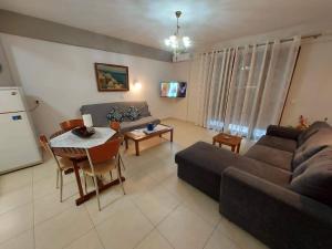 a living room with a couch and a table at Modern Apartment Kallithea 1 in Kallithea Halkidikis