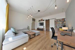 a living room with a couch and a table at Veľký 2i byt pri Opere v priamom centre Banskej Bystrice in Banská Bystrica