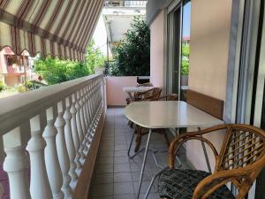 a patio with a table and chairs on a balcony at APARTMENTS HARIS in Olympiaki Akti