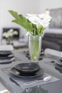 a vase filled with white flowers sitting on a table at coaSTal apartment 1 in Split