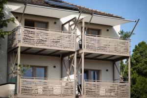 a building with balconies on the side of it at Pannonia Appartements 2 in Neusiedl am See