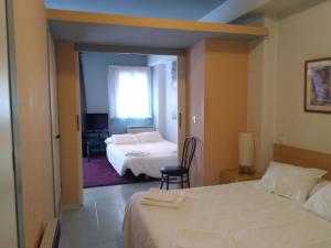 a hotel room with two beds and a window at Casa Baratura in Cangas del Narcea