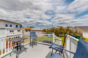 a balcony with two chairs and a table on it at Fun and Sun in Hampton