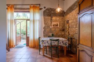 a dining room with a table and a stone wall at Stella Nord Podere Carbone in Grosseto