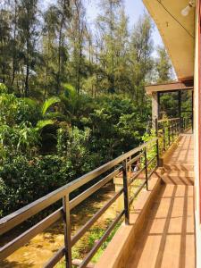 a wooden walkway leading into a garden at Coorg West End Home Stay in Madikeri