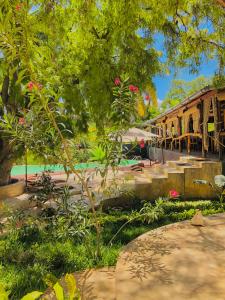 a painting of a garden with flowers and a building at Ifaty Beach Club Resort in Ifaty
