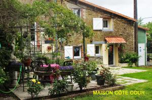 a house with a bunch of plants in front of it at Chez Martine et Bernard in Saint-Vincent-Sterlanges