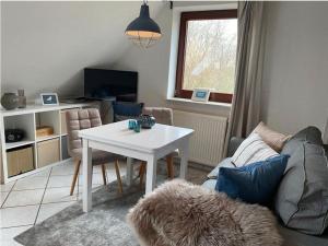 a living room with a white table and a couch at Ferienhof Jepsen in Westerholz