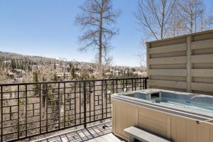 a hot tub on a balcony with a view at Aspen Ridge 9 in Telluride