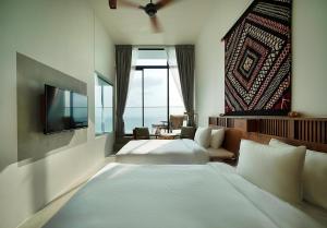 a hotel room with two beds and a television at Granbell Hotel Colombo in Colombo