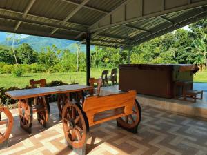 a wooden table and a cart on a patio at Lorenzo's Farm and Leisure in Santo Tomas