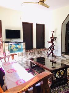 a living room with a couch and a table at Coorg West End Home Stay in Madikeri