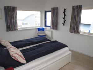 Ein Bett oder Betten in einem Zimmer der Unterkunft Ferienhaus SEABIRD OOST150