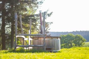 una casa exterior de madera en un campo con árboles en Landhotel Altes Zollhaus en Hermsdorf