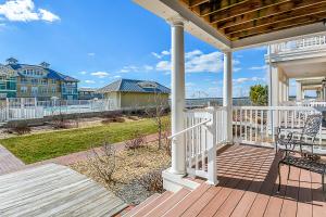a porch of a house with a bench on it at Sunset Island - Beachside Mews 1 & 2 in Ocean City
