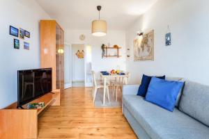 ein Wohnzimmer mit einer Couch und einem Tisch in der Unterkunft La Ola Beach House in Portocolom