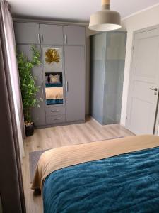 a bedroom with a bed and a potted plant at Hubane Olevi Apartment in Võru